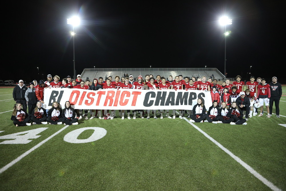 Football team with Bi-District Champs sign