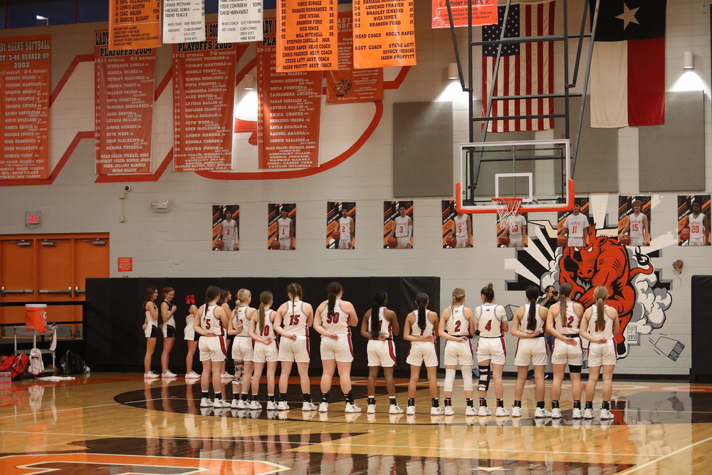 Lady Rockets stand for the pledge
